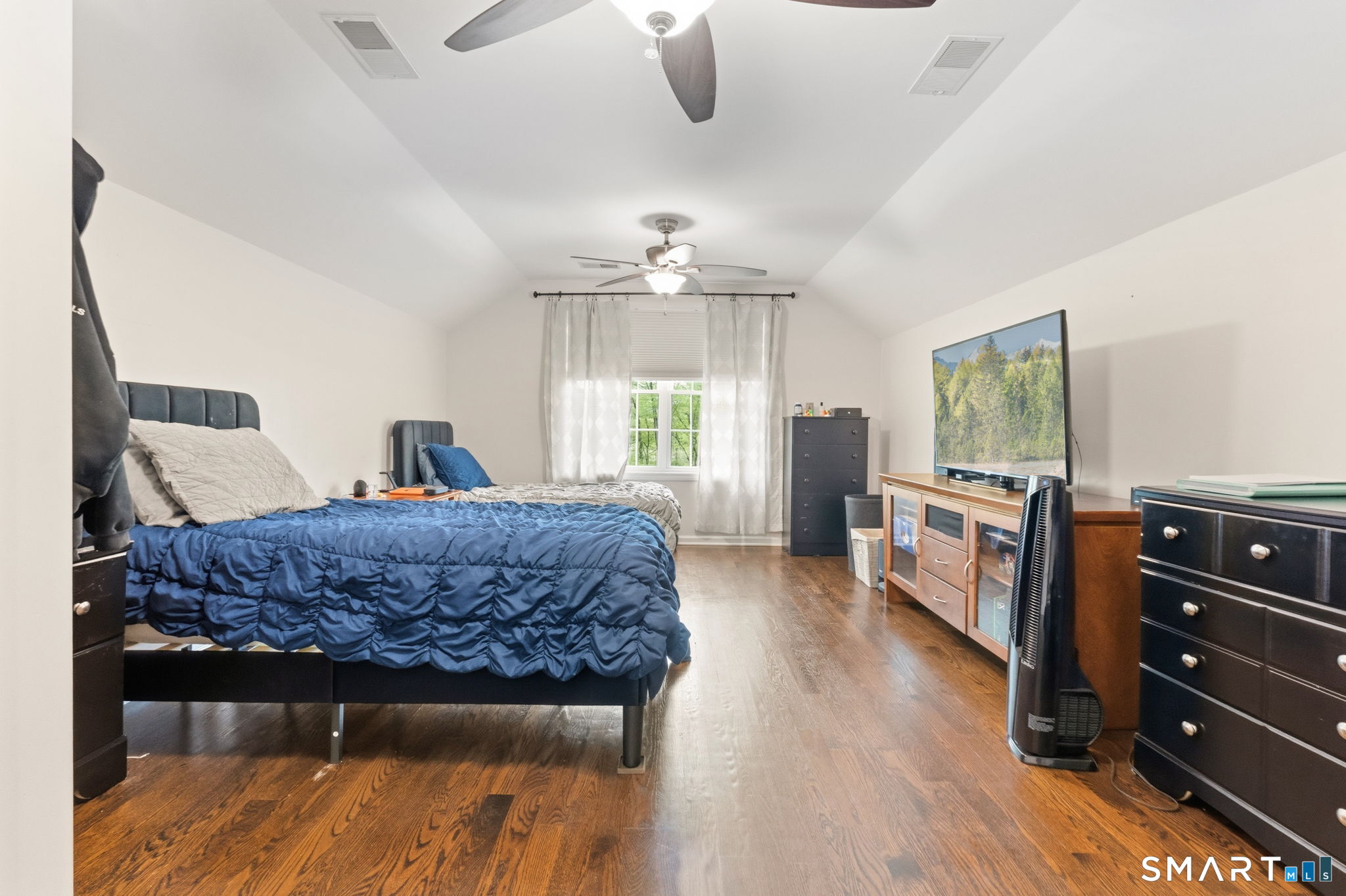 160 Canal Road Suffield, CT 06078 - Photo 26 of 40 a bedroom with a bed and wooden floor