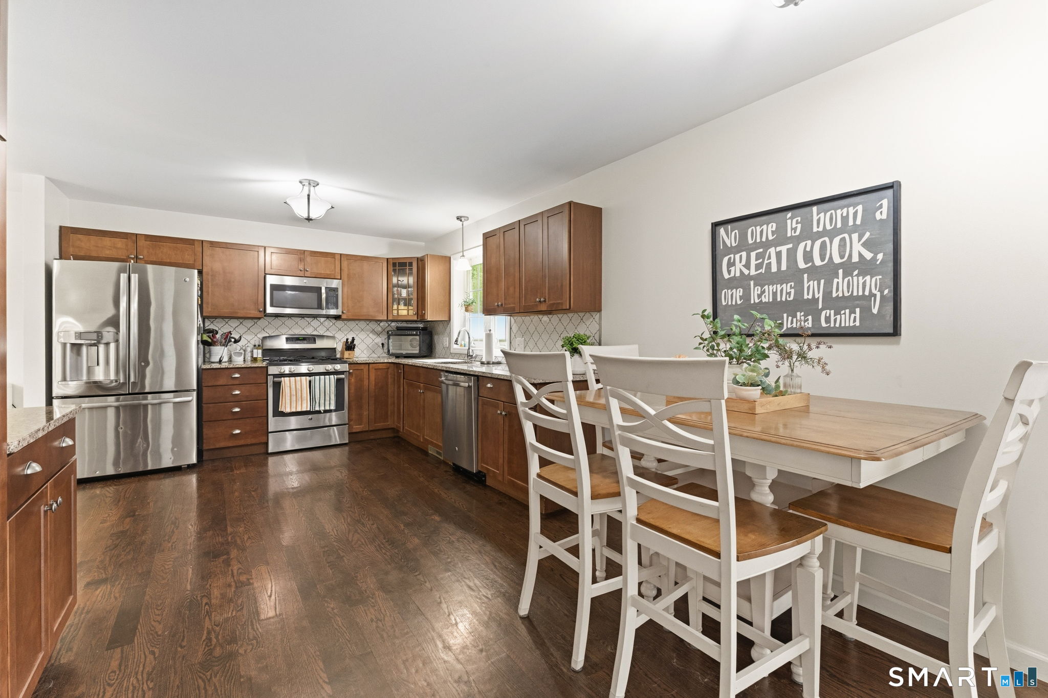 160 Canal Road Suffield, CT 06078 - Photo 8 of 40 a view of a kitchen with wooden floor and stainless steel appliances