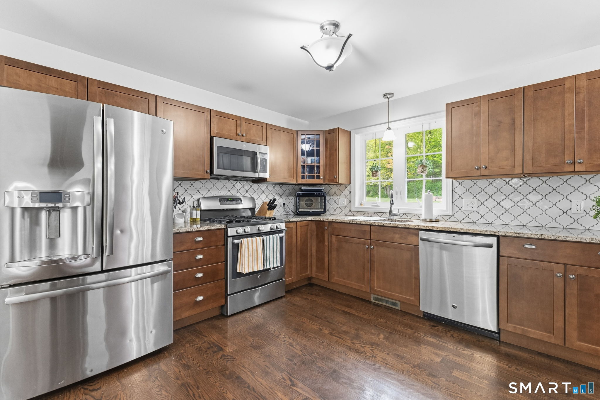 160 Canal Road Suffield, CT 06078 - Photo 9 of 40 a kitchen with granite countertop a refrigerator stove top oven and sink