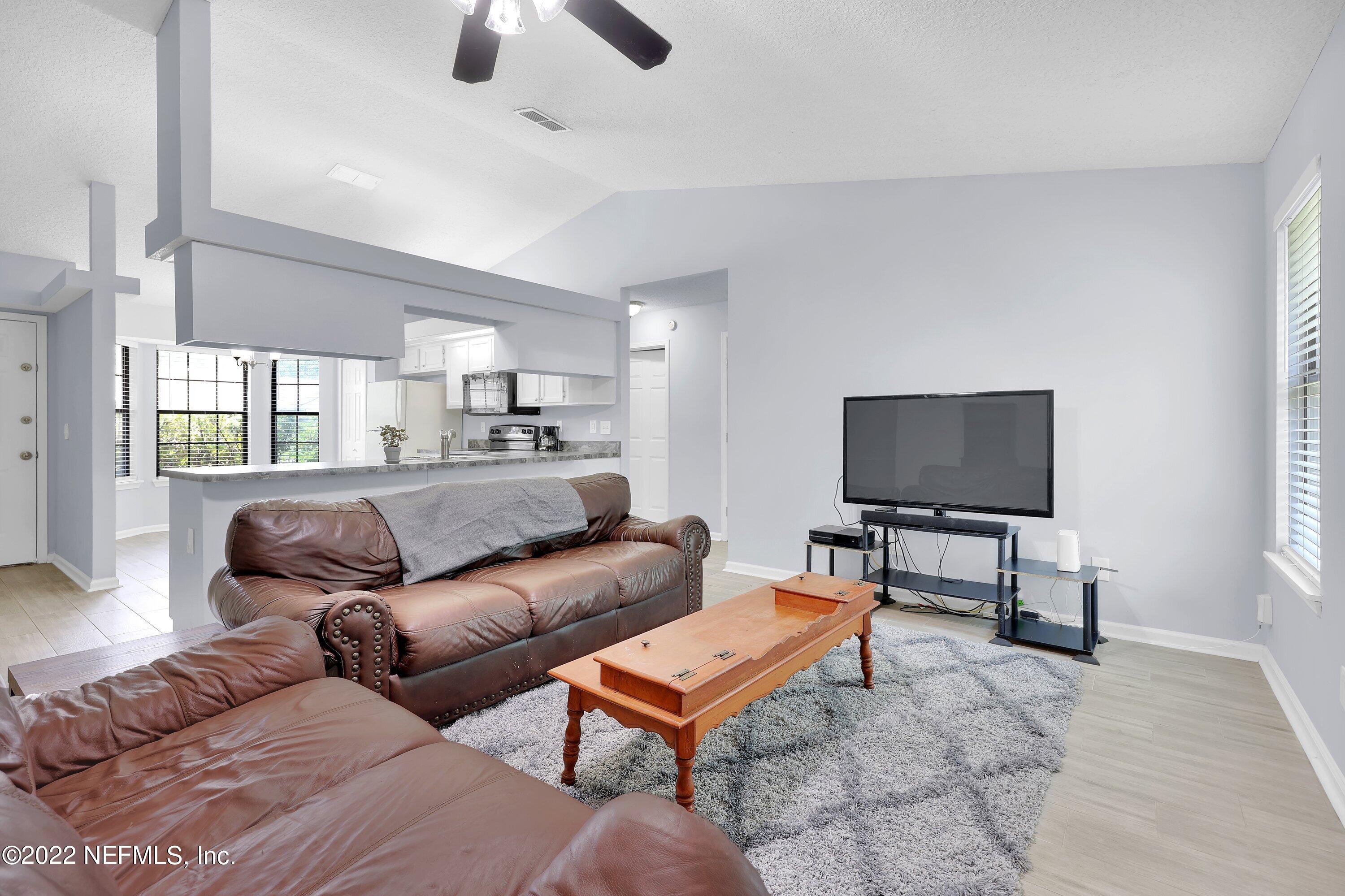 3248 Dowitcher Lane Orange Park, FL 32065 - Photo 11 of 26 a living room with furniture and a flat screen tv