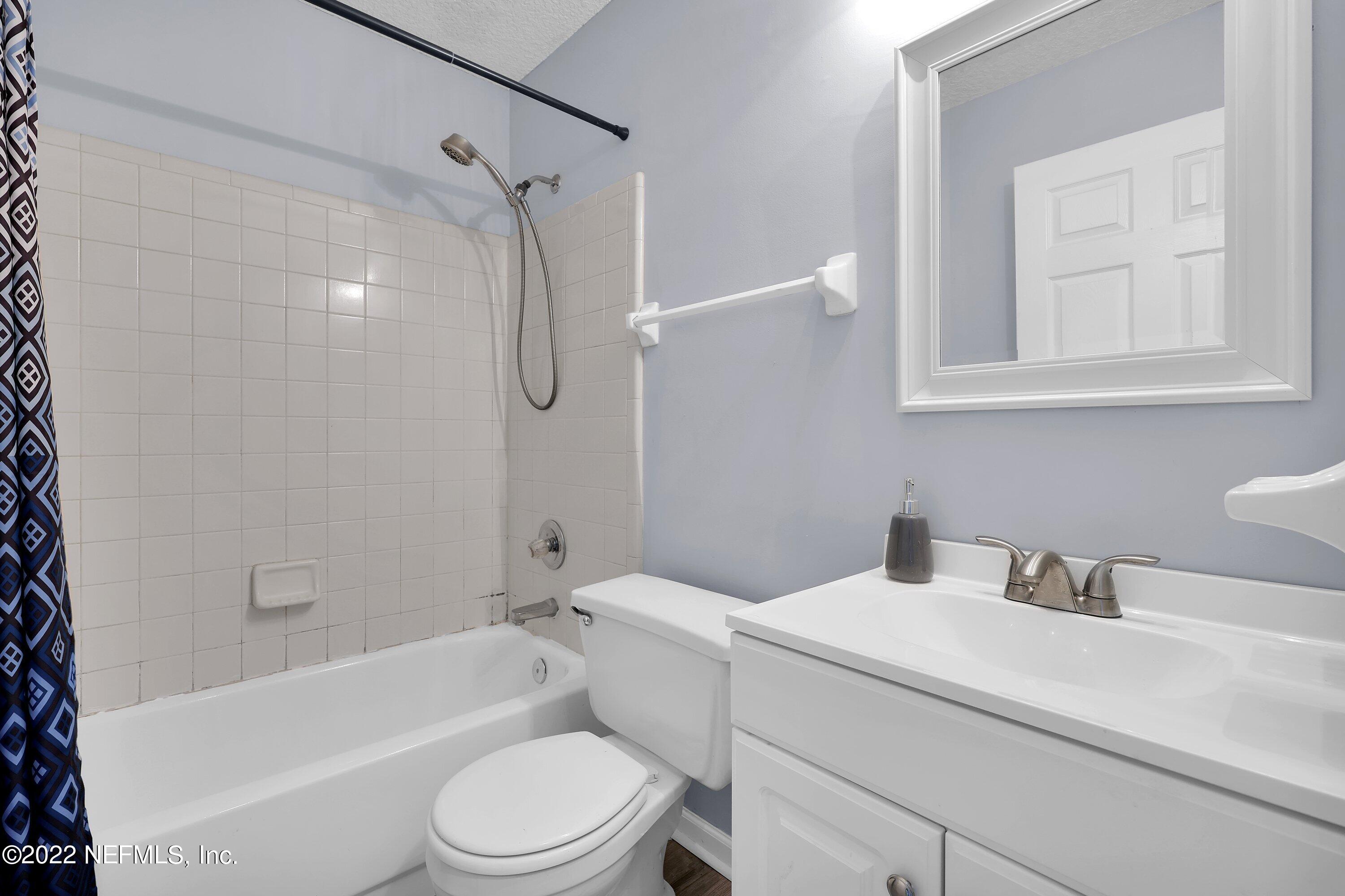 3248 Dowitcher Lane Orange Park, FL 32065 - Photo 14 of 26 a bathroom with a toilet sink vanity shower and bathtub