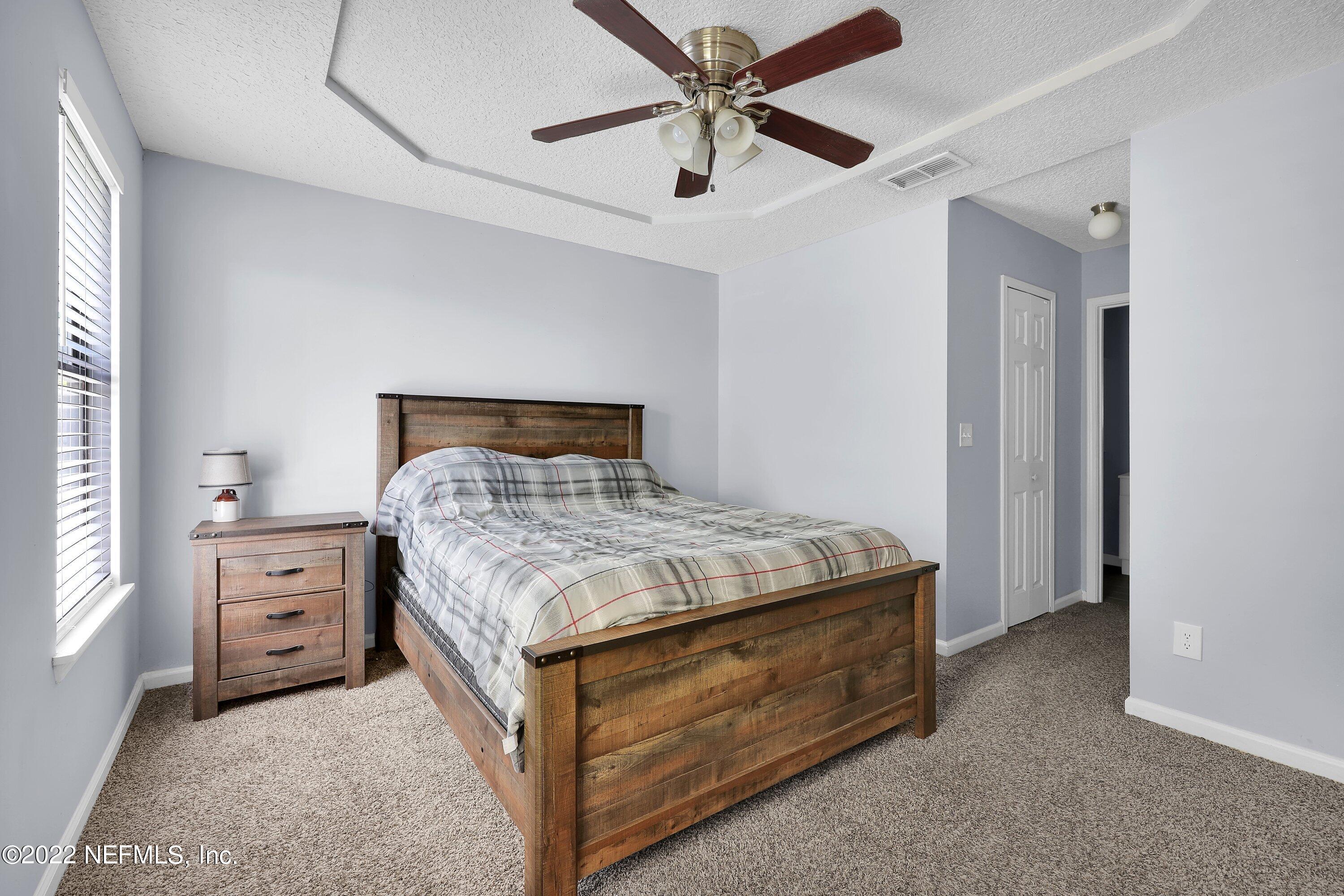 3248 Dowitcher Lane Orange Park, FL 32065 - Photo 15 of 26 a bedroom with a bed and a dresser