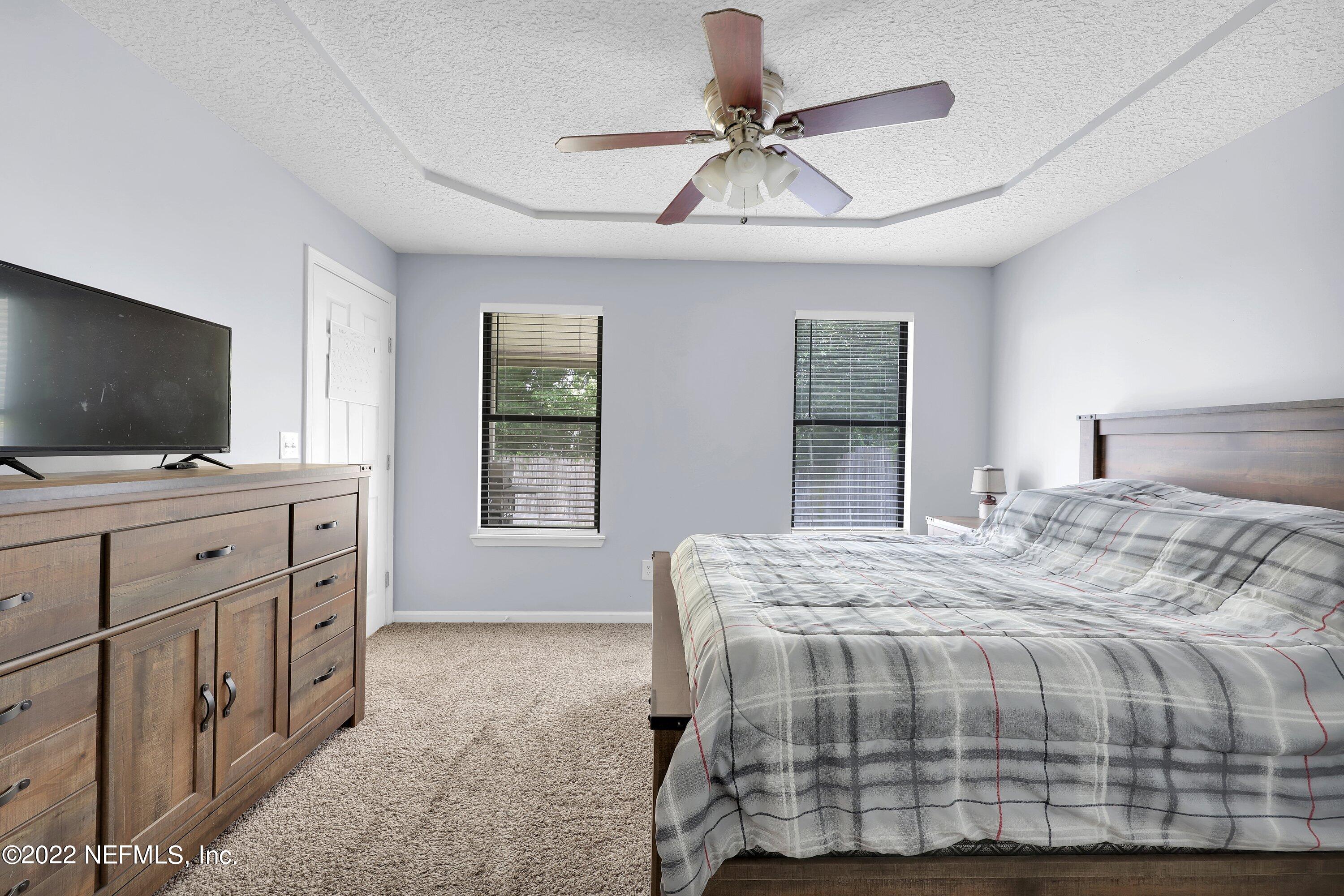 3248 Dowitcher Lane Orange Park, FL 32065 - Photo 16 of 26 a bedroom with a bed and a flat screen tv