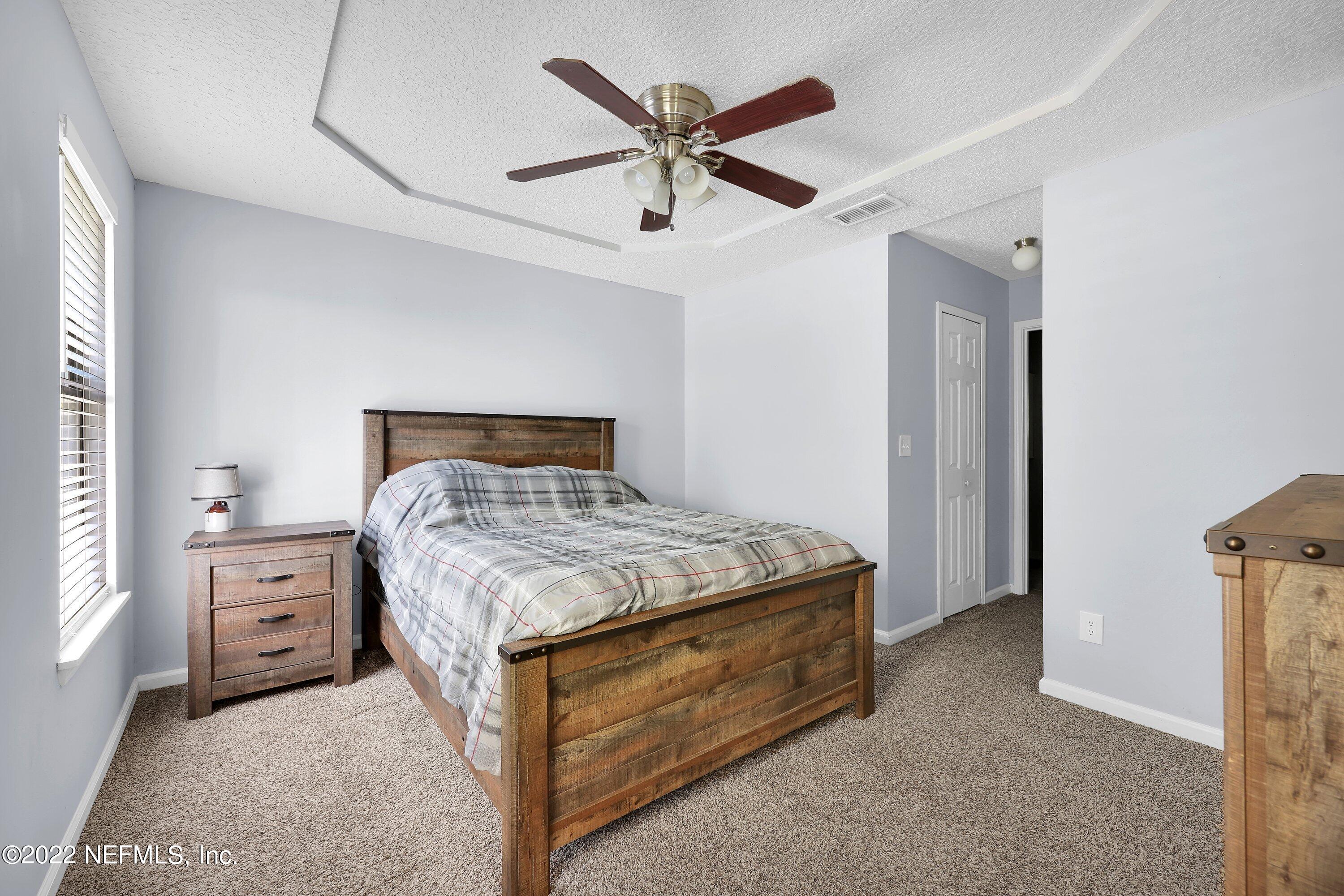 3248 Dowitcher Lane Orange Park, FL 32065 - Photo 17 of 26 a bedroom with a bed and window