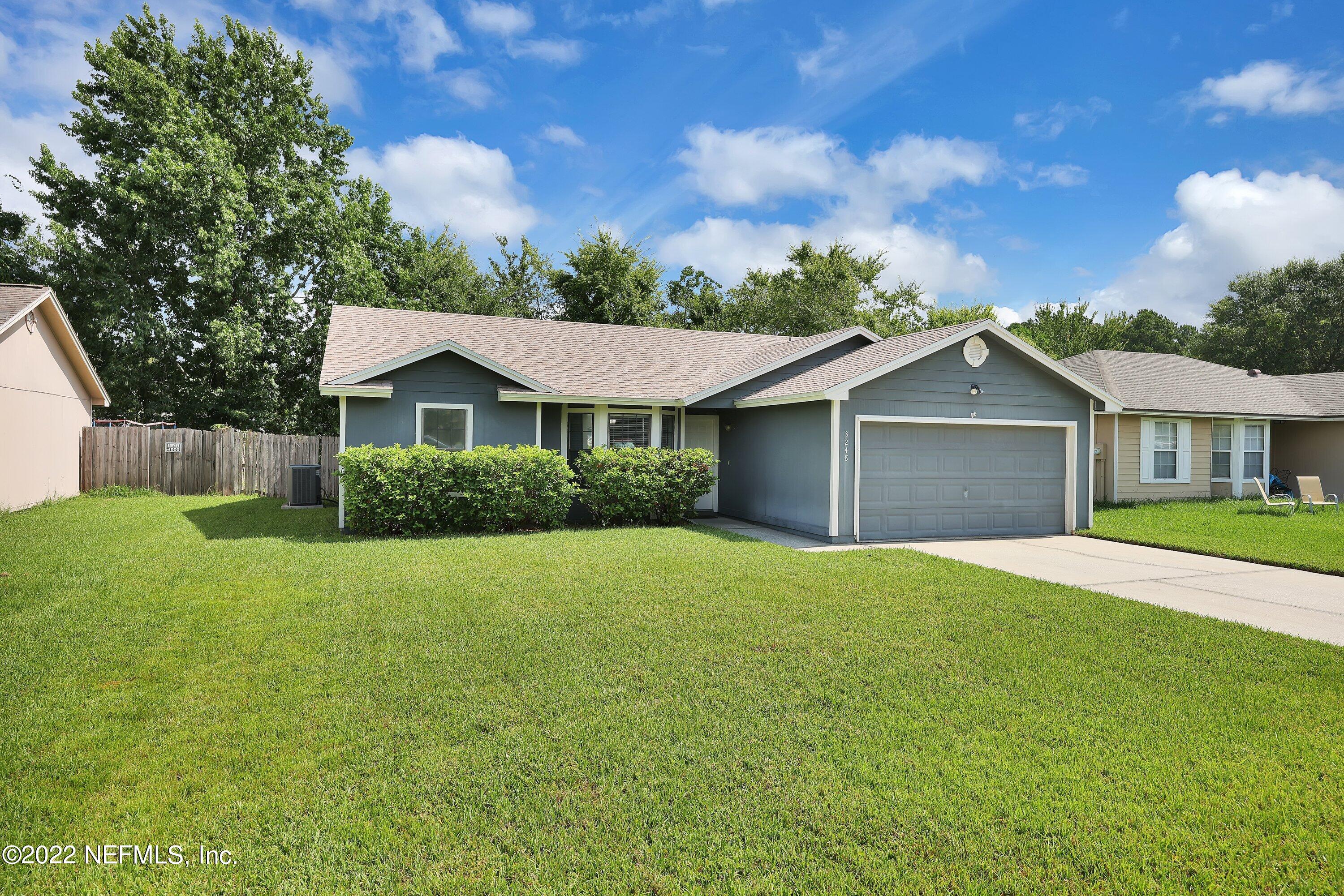 3248 Dowitcher Lane Orange Park, FL 32065 - Photo 3 of 26 a front view of a house with a yard and garage