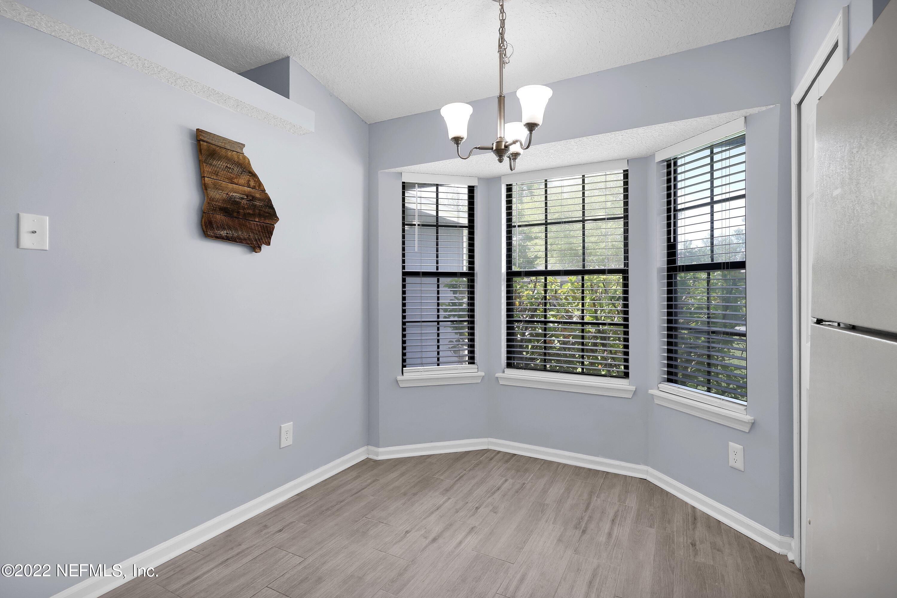 3248 Dowitcher Lane Orange Park, FL 32065 - Photo 5 of 26 a view of an empty room with wooden floor and a window