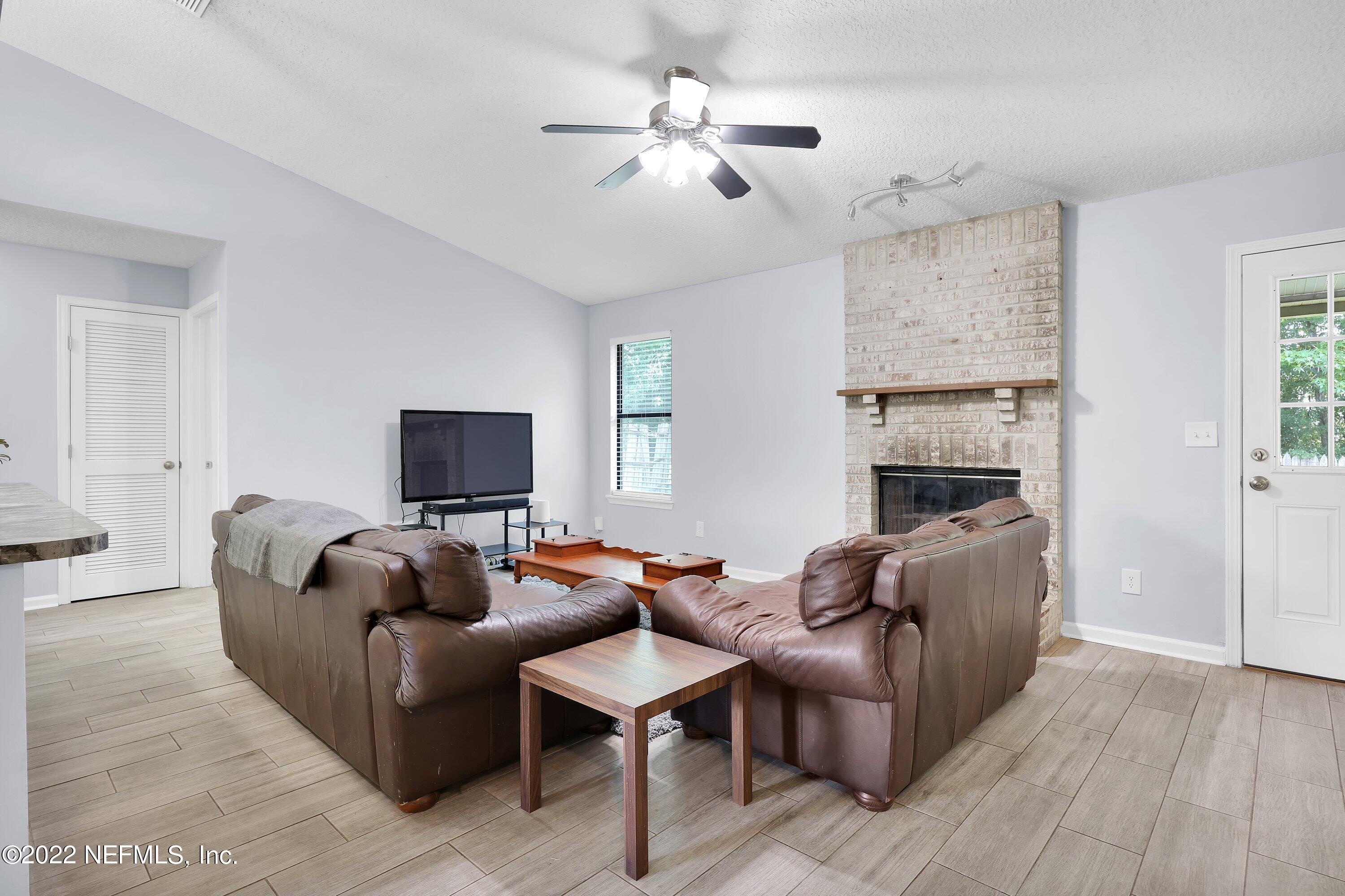 3248 Dowitcher Lane Orange Park, FL 32065 - Photo 9 of 26 a living room with furniture and a flat screen tv