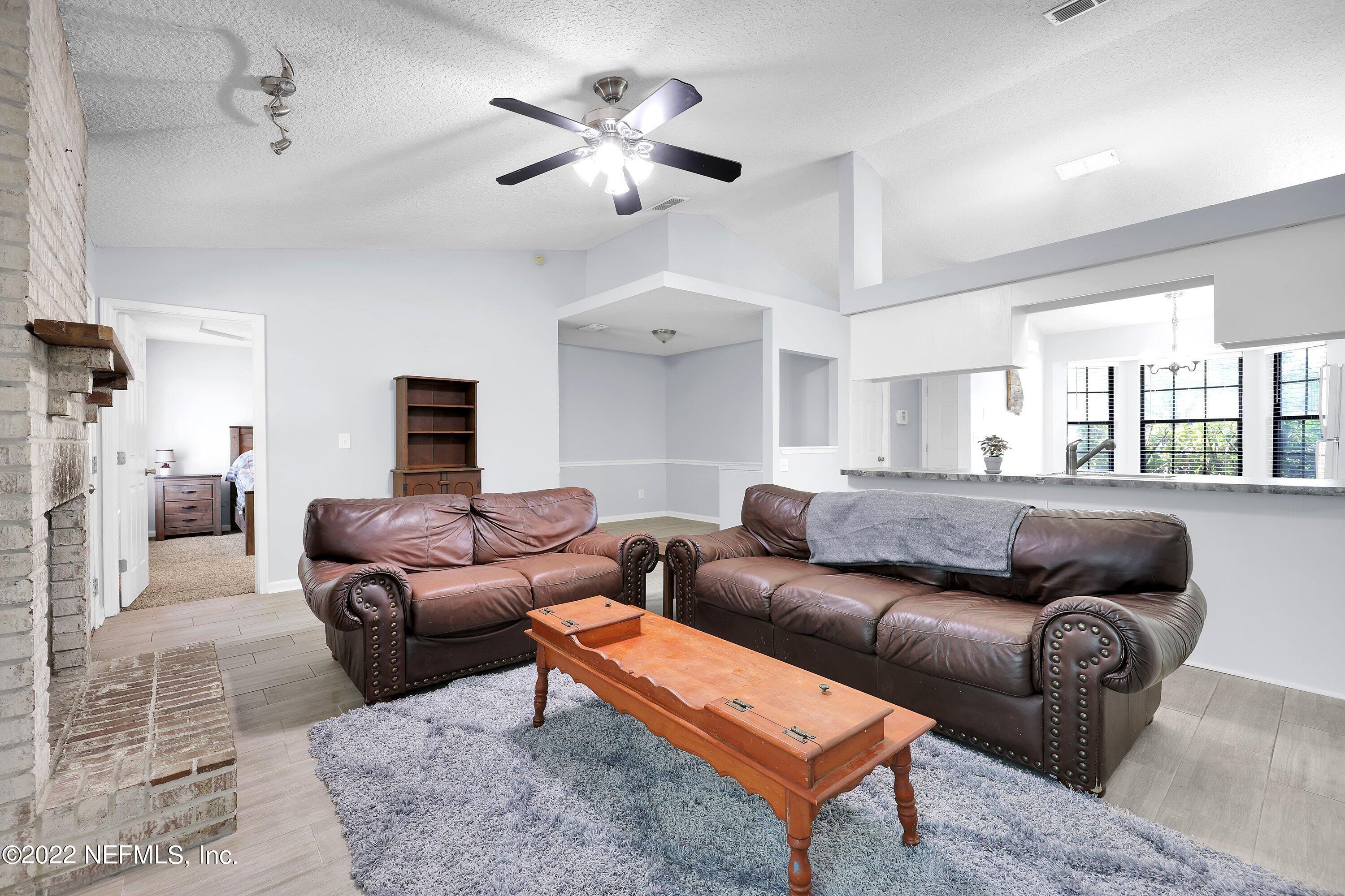 3248 Dowitcher Lane Orange Park, FL 32065 - Photo 10 of 26 a living room with furniture a ceiling fan and a rug