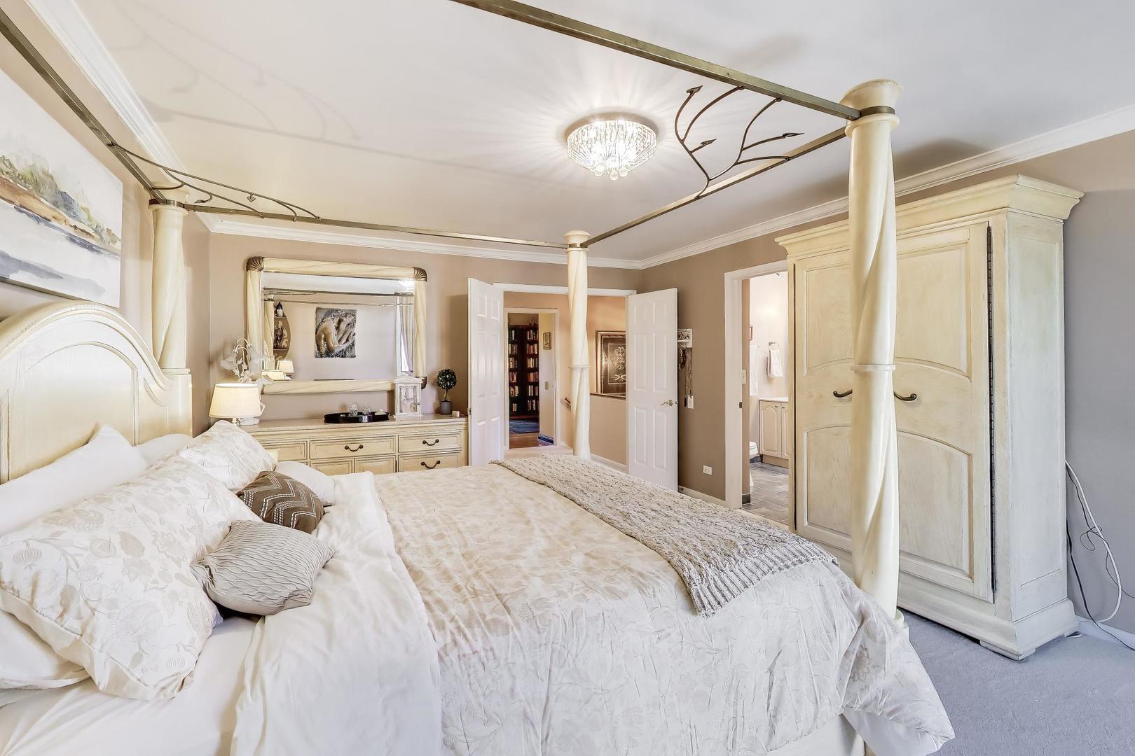 1 Maple Tree Court Elmhurst, IL 60126 - Photo 14 of 34 a bedroom with a large bed and a chandelier