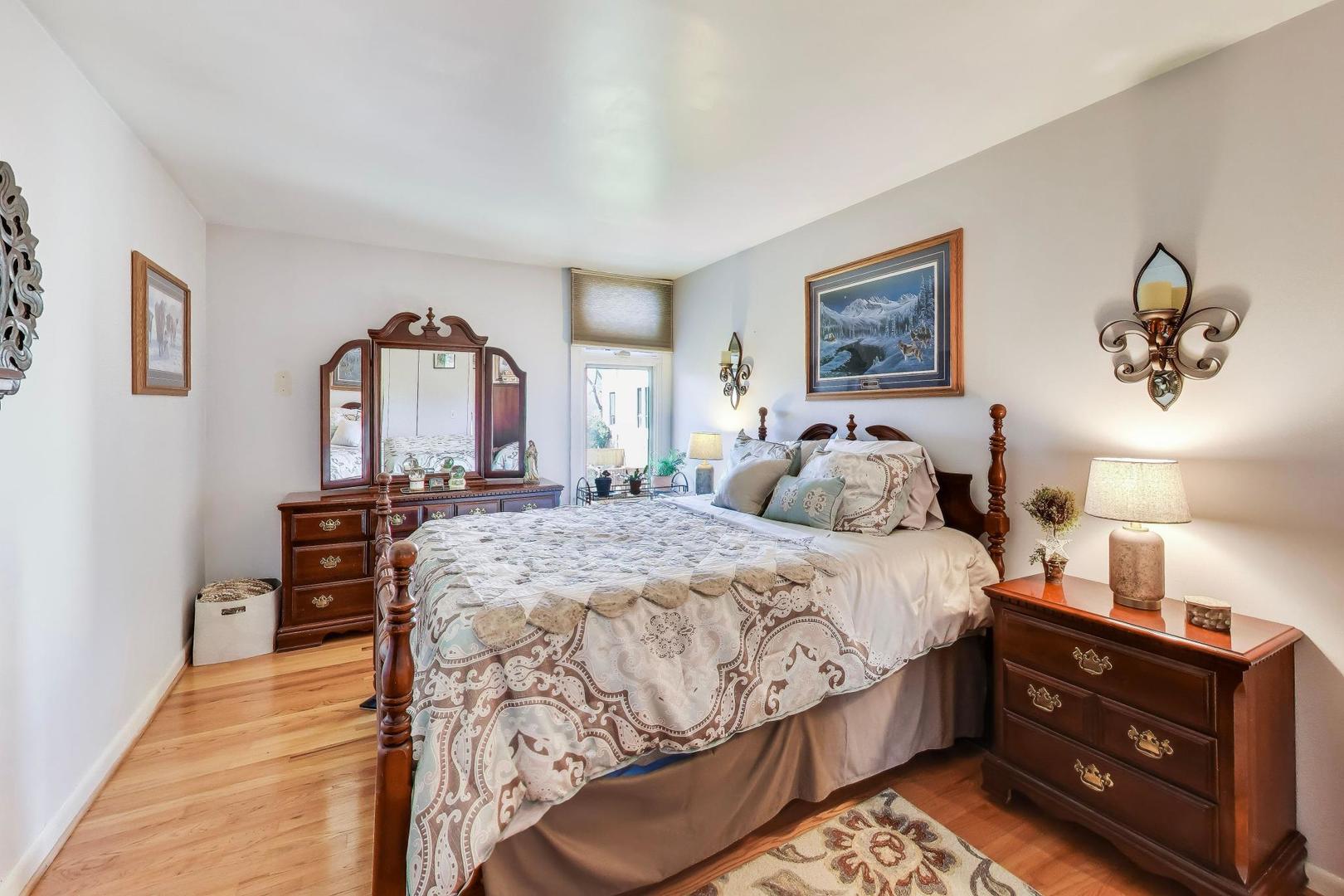 1 Maple Tree Court Elmhurst, IL 60126 - Photo 18 of 34 a bedroom with a bed and wooden floor