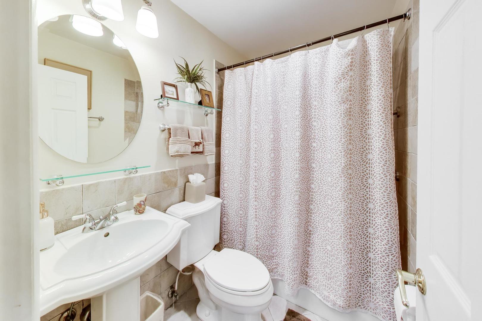 1 Maple Tree Court Elmhurst, IL 60126 - Photo 21 of 34 a bathroom with a sink mirror and a toilet