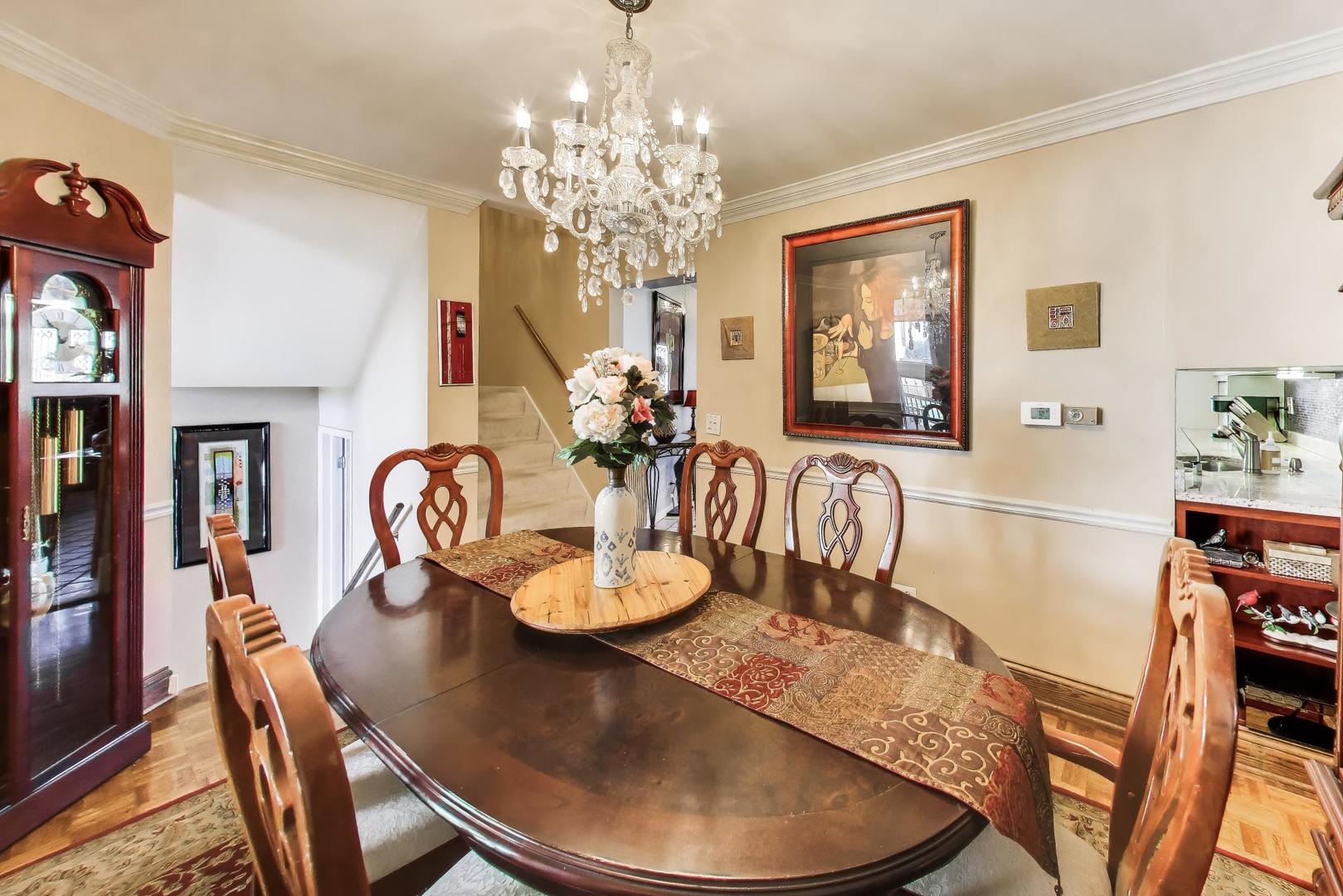 1 Maple Tree Court Elmhurst, IL 60126 - Photo 6 of 34 a view of a dining room with furniture a chandelier and wooden floor