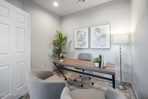 a living room with furniture and a potted plant