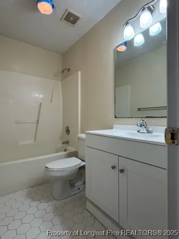 a bathroom with a sink toilet and a mirror