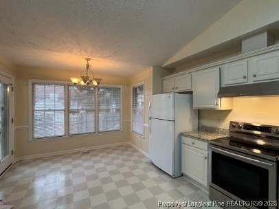 1135 Derbyshire Road Fayetteville, NC 28314 - Photo 6 of 22 a kitchen with granite countertop a refrigerator stove top oven and cabinets