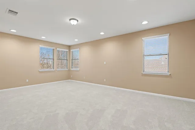 a view of a backyard with table and chairs under an umbrella