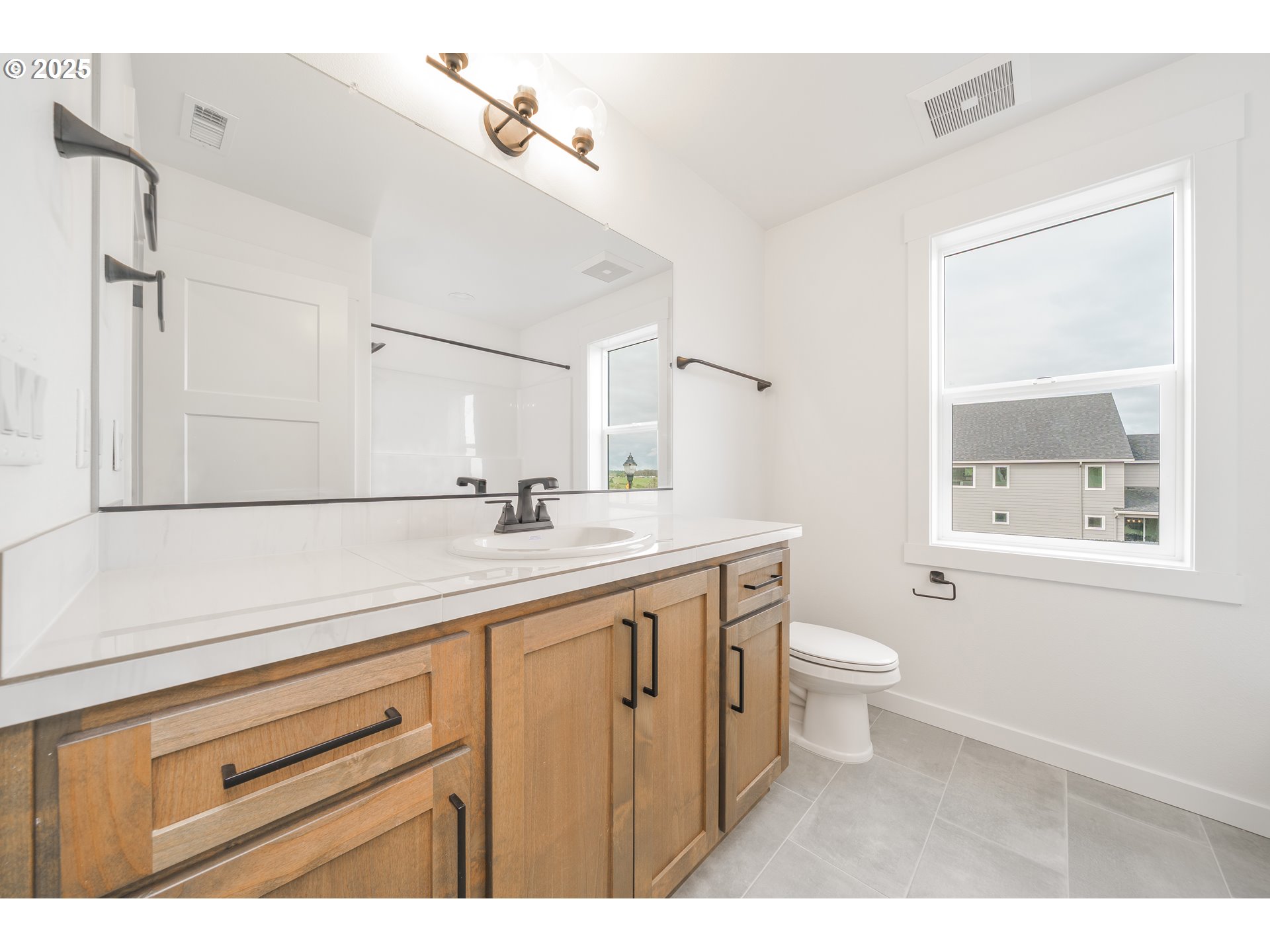 4300 North 12th Way Ridgefield, WA 98642 - Photo 22 of 35 a bathroom with a sink a toilet and a mirror