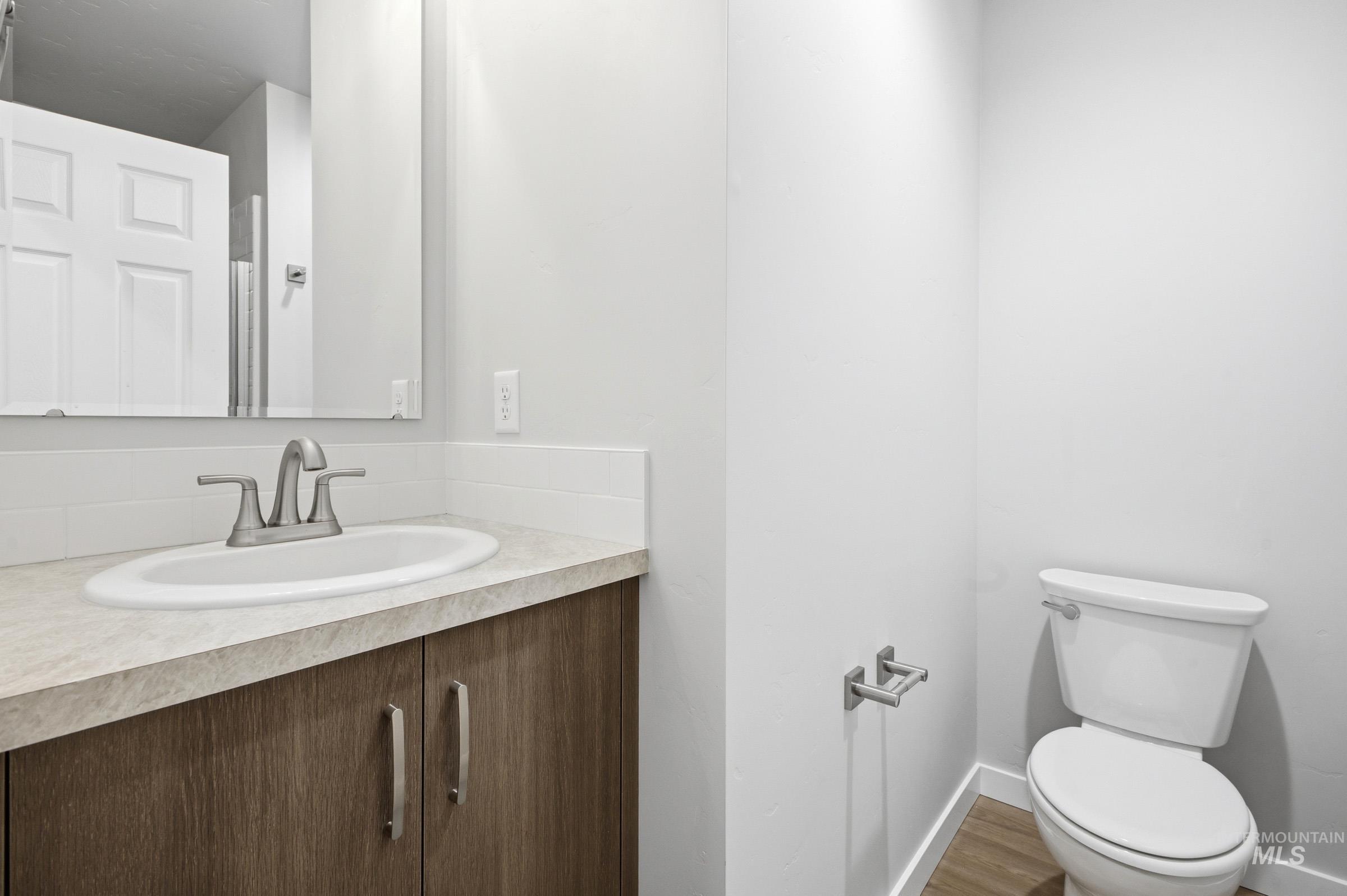 13702 Inman Court Caldwell, ID 83607 - Photo 12 of 23 Bathroom featuring vanity and wood finished floors