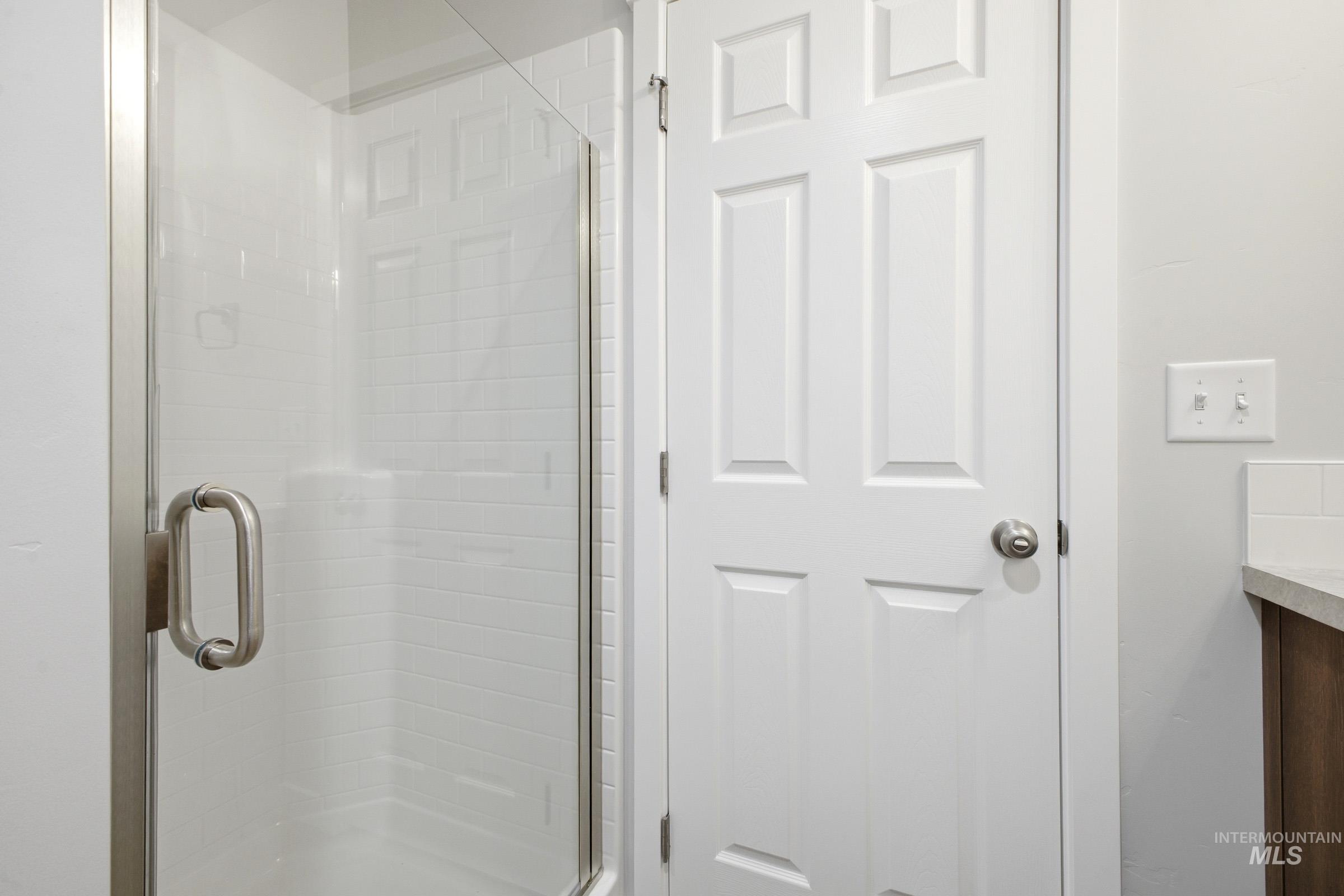 13702 Inman Court Caldwell, ID 83607 - Photo 13 of 23 Bathroom featuring vanity and a shower stall