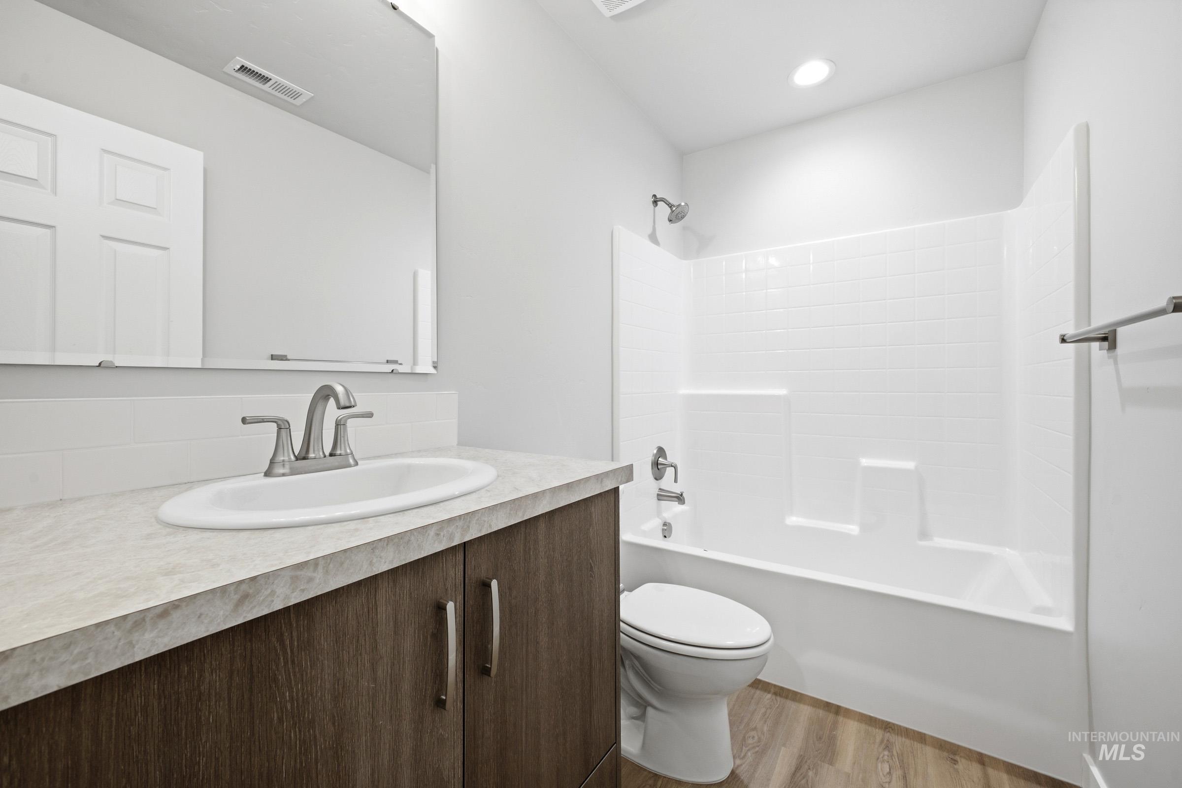 13702 Inman Court Caldwell, ID 83607 - Photo 18 of 23 Bathroom featuring vanity, shower / tub combination, and light wood finished floors