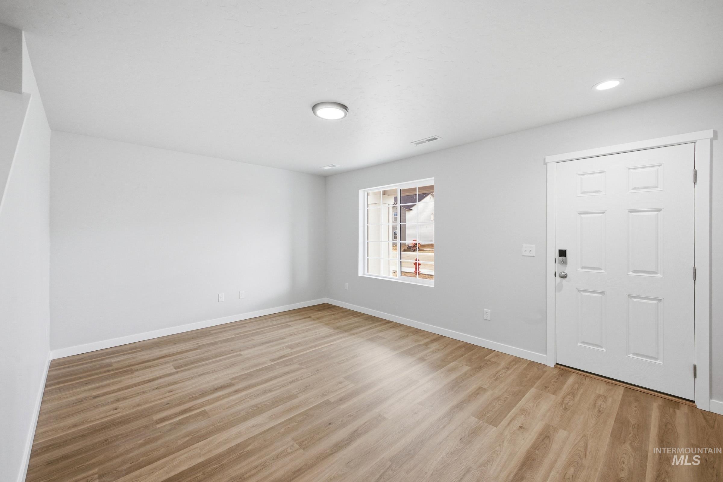 13702 Inman Court Caldwell, ID 83607 - Photo 2 of 23 Foyer entrance with light wood-style flooring and baseboards