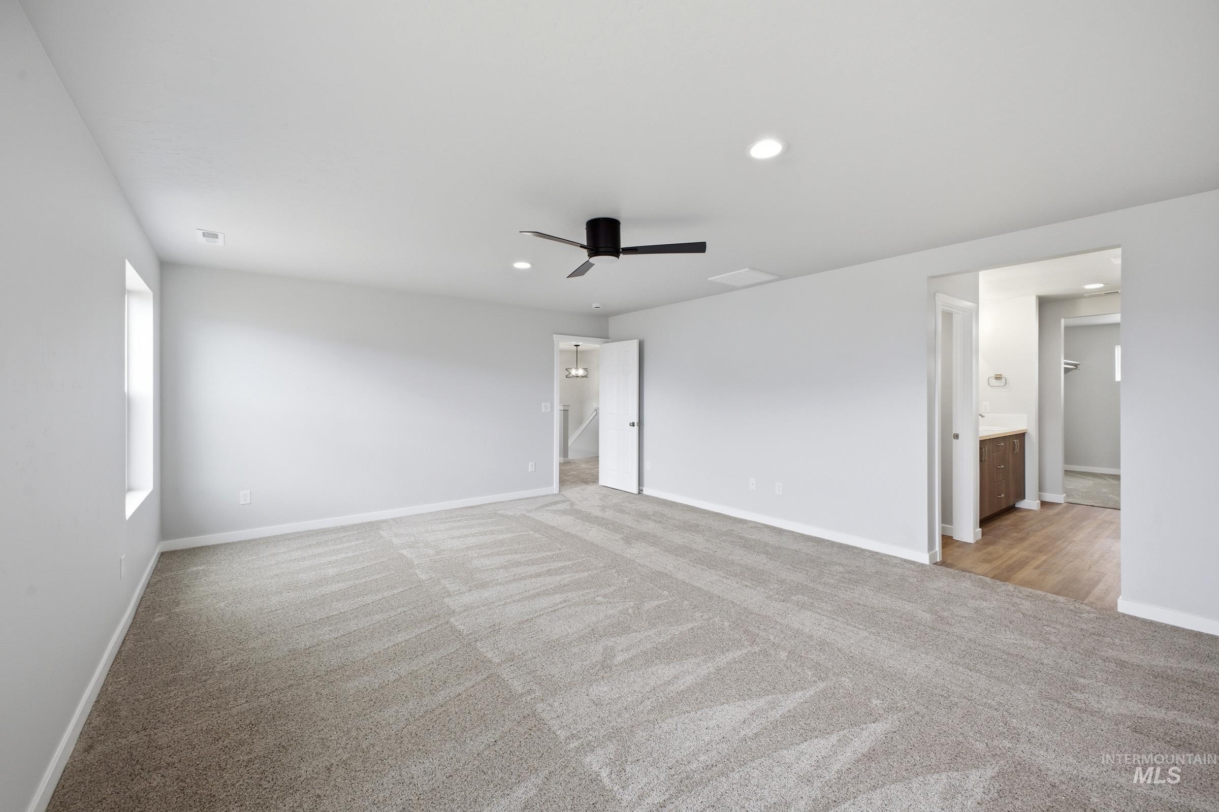 13702 Inman Court Caldwell, ID 83607 - Photo 21 of 23 Unfurnished bedroom featuring ceiling fan, light carpet, recessed lighting, and ensuite bath