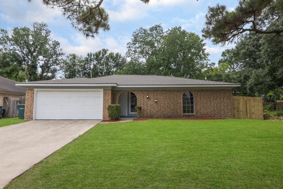 a view of a house with a yard and garage