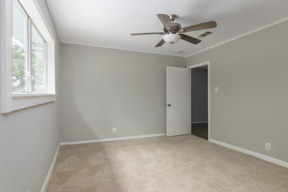 92 Sparrow Way Beaumont, TX 77707 - Photo 13 of 19 a view of an empty room with a ceiling fan and window