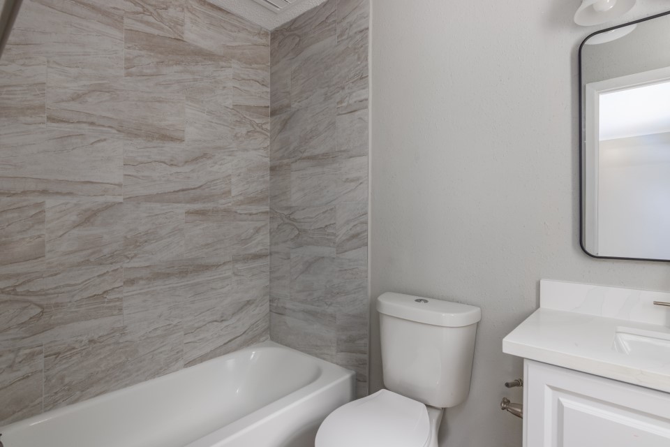 92 Sparrow Way Beaumont, TX 77707 - Photo 17 of 19 a white toilet sitting next to a bath tub