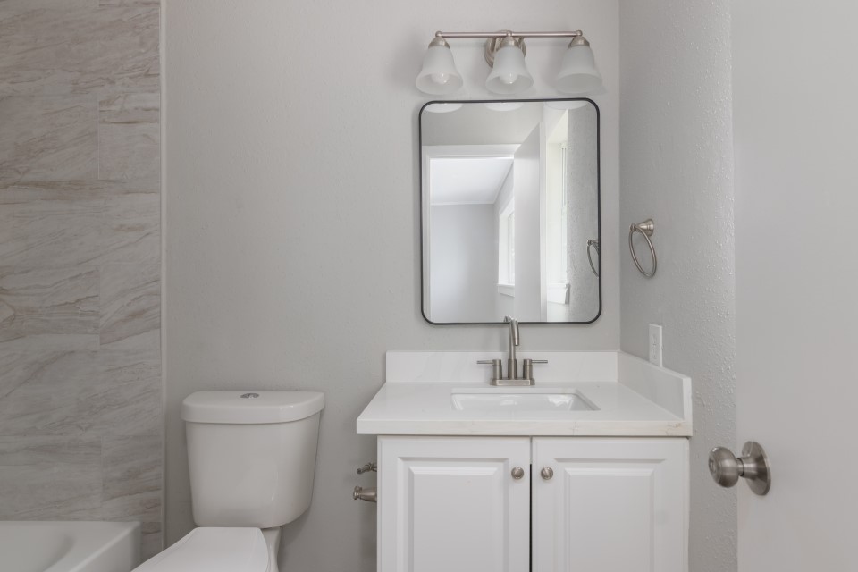 92 Sparrow Way Beaumont, TX 77707 - Photo 18 of 19 a bathroom with a toilet sink and mirror