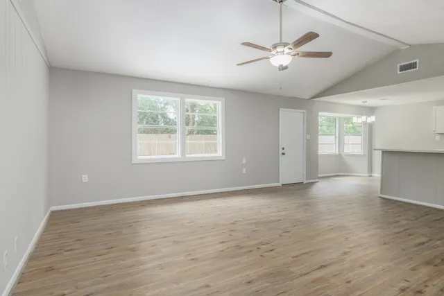 wooden floor in an empty room with a window