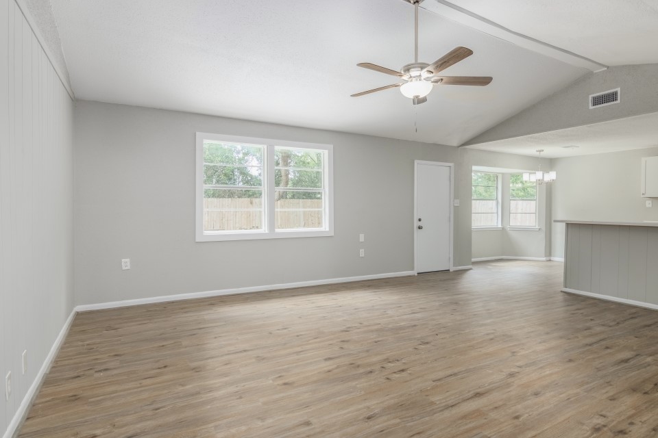 92 Sparrow Way Beaumont, TX 77707 - Photo 4 of 19 wooden floor in an empty room with a window