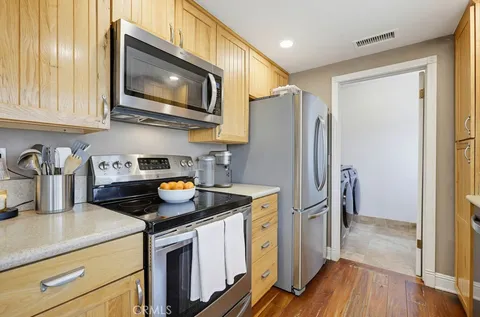 a kitchen with stainless steel appliances granite countertop a refrigerator stove and sink