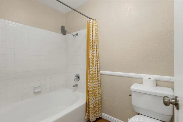 a bathroom with a shower and a toilet