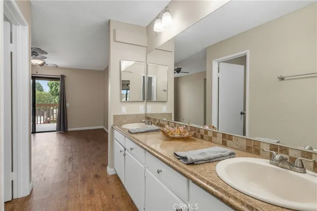 a bathroom with a granite countertop sink and a large mirror