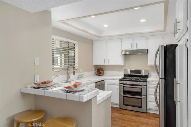 a kitchen with refrigerator and stove