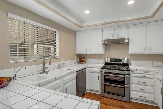 a kitchen with a stove and a sink