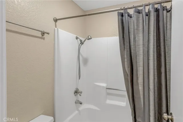 a bathroom with a shower and a tub