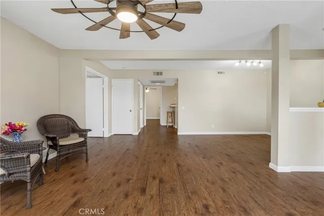 a view of room with wooden floor fan and windows