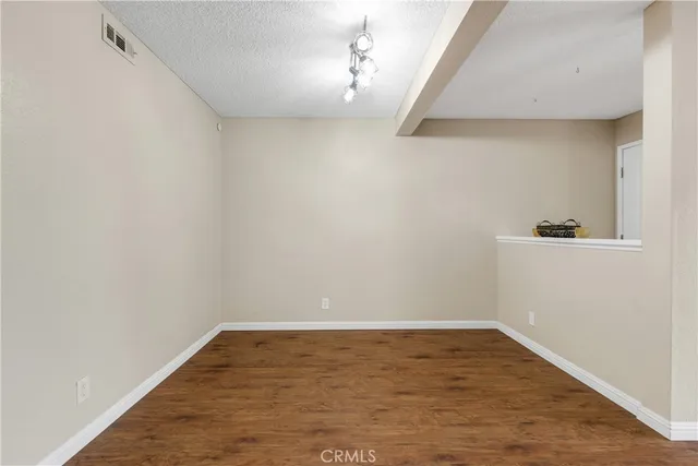a view of a room with wooden floor and carpet