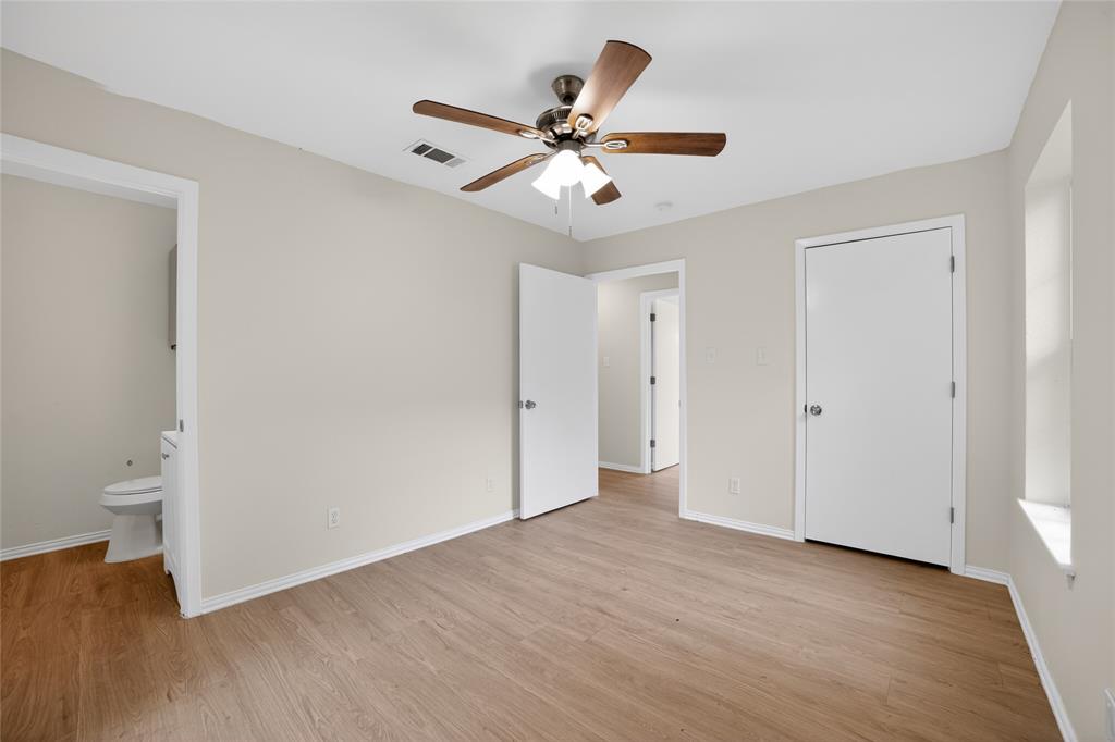 808 Park Street Commerce, TX 75428 - Photo 13 of 29 This room features light wood-look flooring, neutral wall paint, and a ceiling fan with integrated lighting