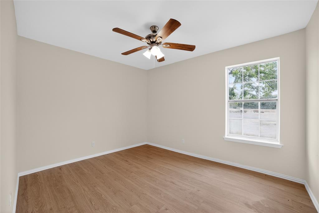 808 Park Street Commerce, TX 75428 - Photo 17 of 29 This interior space features light-colored walls and wood-look flooring