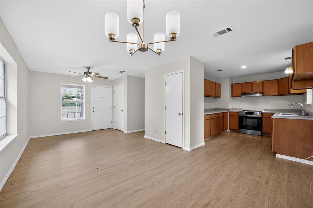 808 Park Street Commerce, TX 75428 - Photo 7 of 29 Open concept living space featuring light wood-style flooring throughout