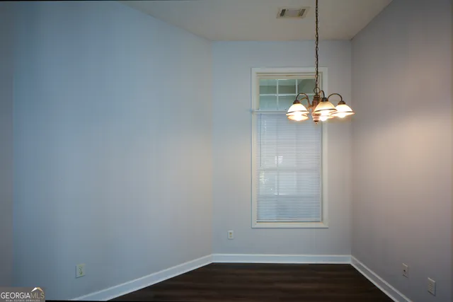 a dining room with furniture and chandelier