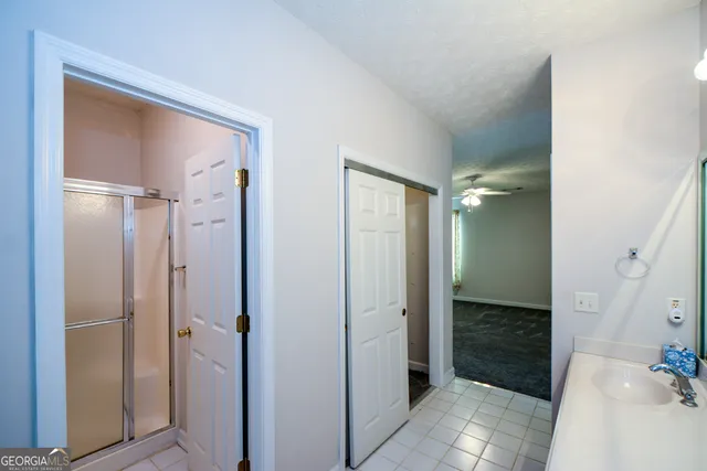 a bathroom with a glass shower door