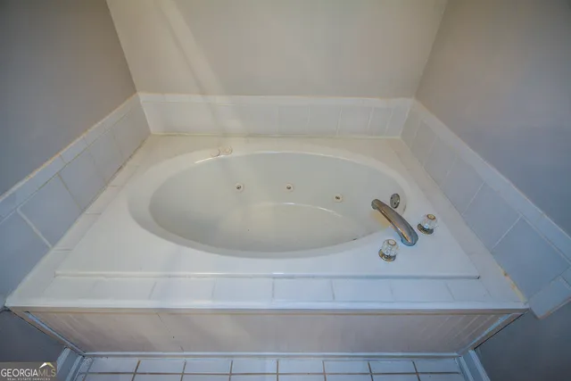 an empty room with fan and windows