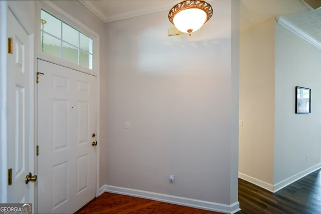 an empty room with wooden floor