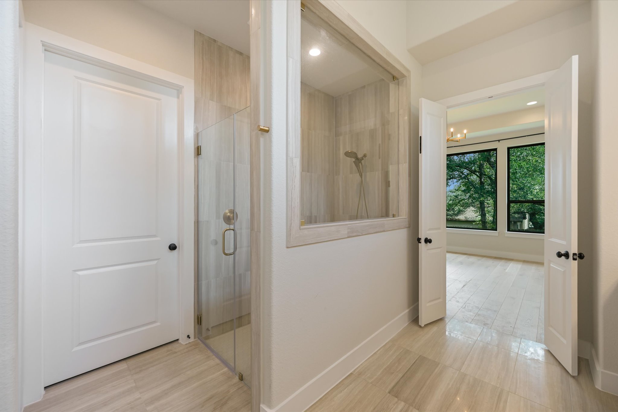 913 Presa Arriba Road Austin, TX 78733 - Photo 19 of 30 A private shower area with tile flooring provides a refreshing escape, connecting to an adjacent room through French doors.