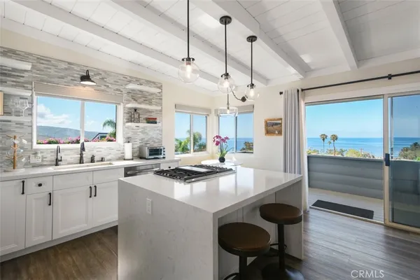a kitchen with sink cabinets and wooden floor