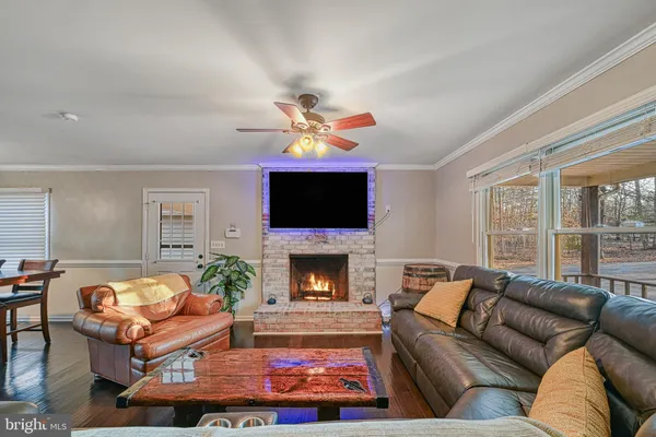 a living room with furniture a flat screen tv and a fireplace